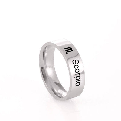 Silver ring with 'Scorpio' and zodiac symbol on a white background