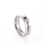 Silver ring with 'Scorpio' and zodiac symbol on a white background