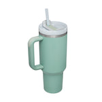 Mint green tumbler with handle and straw on a white background
