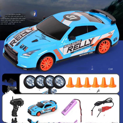 Toy racing car with remote control, batteries, and cones on a blue background