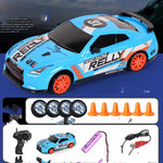 Toy racing car with remote control, batteries, and cones on a blue background