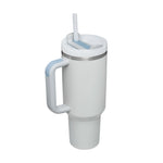 White tumbler with handle and straw on a white background
