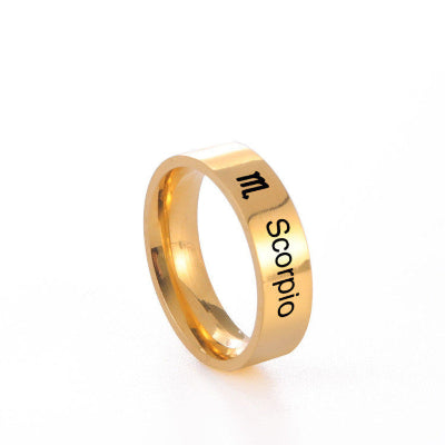 Gold ring with 'Scorpio' engraving on a white background