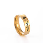 Gold ring with 'Scorpio' engraving on a white background