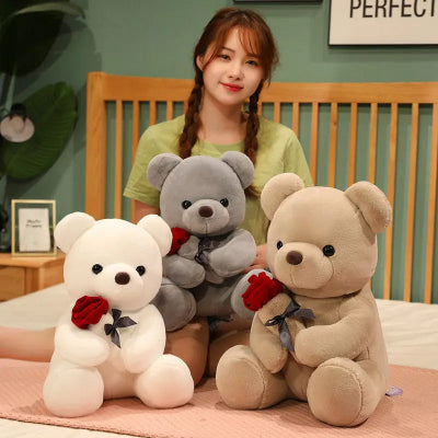 Woman with three teddy bears on a bed in a room setting