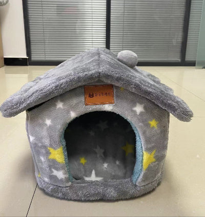 Gray pet bed with star pattern on a light-colored floor.