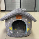 Gray pet bed with star pattern on a light-colored floor.