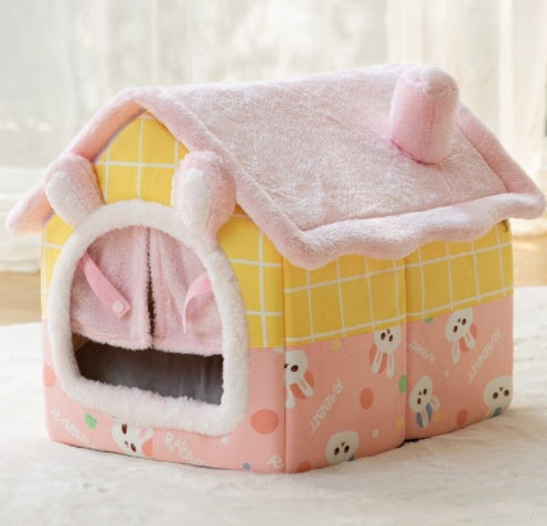 Pink and yellow pet house with cartoon designs on a light background