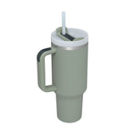 Green insulated mug with handle and straw lid on a white background