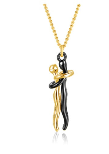 Gold and black pendant necklace on a white background