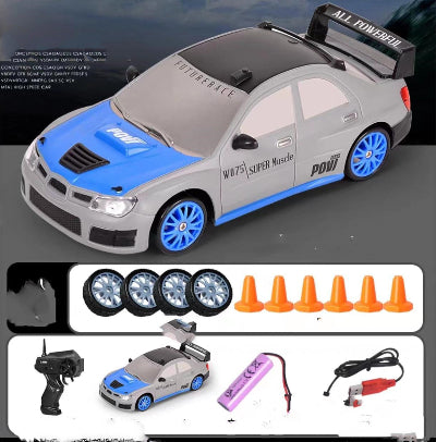 Toy car with remote control, batteries, and cones on a dark background